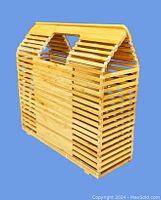 Front and side view of bamboo handbag showing rectangular form and slatted construction with handles.