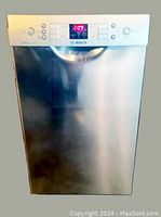 Front view of the Bosch dishwasher showing stainless steel door with control panel and active display screen.