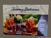 Box front showing Tommy Bahama branding and details about the 16-piece glass set, with capacity sizes for 8 13oz and 8 16oz glasses
