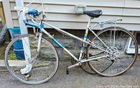 Full side view of the vintage Raleigh bicycle showing frame, drop handlebars, leather saddle, and rear rack