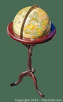 Side angle view of the vintage Replogle 12-inch globe on wood tripod stand