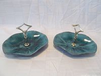 Pair of Blue Mountain Pottery dishes with central silver metal handles on a white background