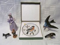 Group photo of 5 Goebel Hummel figurines and 1 boxed Goebel Wildlife Plate with Bluefinch design.