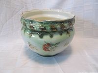 Full view of the Grimwades Ltd flower pot showing overall shape, scalloped top edge, green-to-white gradient coloring, and floral decoration on body.