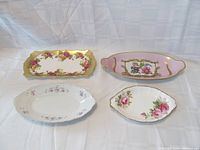 Overview of the four porcelain celery dishes showing their shapes, colors, and floral designs.