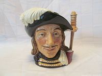 Front angled view of Royal Doulton Character Toby Mug 'Aramis' showing detailed face, feathered hat and part of sword handle on the back.