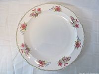 Top view of 13.5 inch round Shelley bone china serving dish showing floral pattern around rim and gold trim.