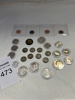 Overall view of all coins laid out with capsules and flips