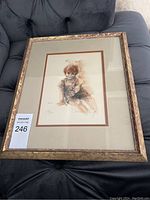 Framed art print showing a young red-haired child sitting, signed and numbered by Connie King.