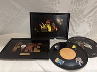 Set of 4 Couroc trays and plates displayed on white fabric