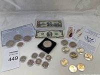 Coins and currency from US collection including half dollars and two dollar bills