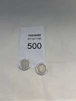 Obverse view of both Liberty Head nickels (1883 and 1912) in clear capsules with lot card