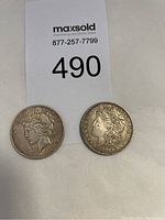 Two silver coins side by side: 1926 Peace Silver Dollar on the left and 1921 Morgan Silver Dollar on the right.