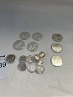 Full tray view showing four Silver Eagles, three Susan B. Anthony dollars, one Kennedy half dollar and cluster of quarters
