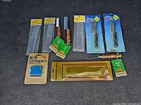 Overview of all 10 pet combs laid out showing variety in handle material and packaging