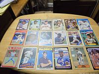 Photo showing 18 vintage baseball rookie cards arranged on a table with various players and teams.