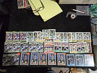 Photo showing an array of 40 Mark McGwire baseball cards laid out on a table including different sets and designs