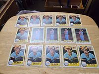 Photo showing all 15 Paul Molitor baseball cards spread out on a wooden surface, displaying the front sides predominantly in Milwaukee Brewers uniform, including Fleer and Donruss cards.