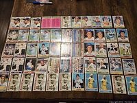 Wide view of 55 baseball cards laid out on table, showing various team players and checklists from 1979 Topps series.