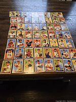 58 Topps Heritage baseball cards spread out on a wooden table showing various players from different MLB teams in vintage card design.