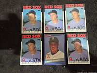 Front side group photo of the six Roger Clemens baseball cards from 1986, five Topps and one Donruss in Boston Red Sox uniform.