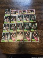Various 1981/82 Topps basketball cards displayed on wooden surface featuring Larry Bird and other players.
