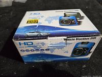 Front and top view of the product box showing the blue dash camera image, HD and Full HD 1080 labeling with world map and car graphics