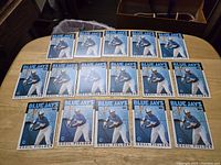 16 identical 1986 Topps Cecil Fielder rookie baseball cards laid out on table in rows.