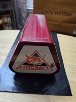 Red rectangular vintage air pump with Foxcraft logo on the triangular end.