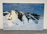 Front angled view of full painting showing snowy rock formation under sky