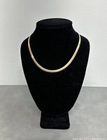 Front view of the two-tone necklace displayed on a black velvet bust.