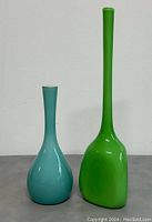 Front view of teal blue and bright green glass vases showing full height and body shapes.