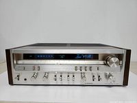 Front view of stereo receiver showing tuning display and control knobs
