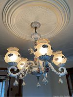 Side view showing five illuminated scrolled arms and ceiling medallion