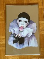 Close-up photo of the Pierrot figure mirror showing detailed artwork and frame