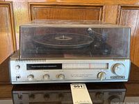 Front view of the Candle vintage FM-AM radio stereo phonograph turntable with dust cover, showing overall condition and front controls.