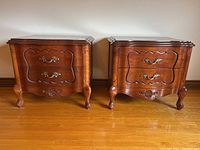 Pair of walnut end tables shown side by side on hardwood floor
