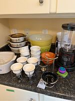 Photo showing all items on counter, including blender, casserole dishes, ramekins, fondue set, and bowls