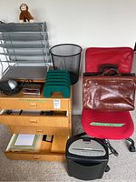 Full view of the lot showing office chair, file cabinet, letter tray, wastebasket, briefcases, paper shredder and office supplies.