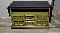 Front view of green drop leaf server with closed drawers and cabinet doors.