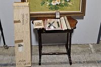 Boxed harp kit with parts, instructions and accessories on a small wooden table.