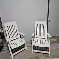 Two white Rubbermaid outdoor chairs side by side showing full front view.