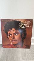 Front cover of Michael Jackson Thriller 12 inch vinyl showing detailed portrait of Michael Jackson.