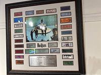 Full front view of framed Beatles memorabilia