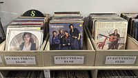 Three wooden record crates labeled "Everything Else" filled with assorted LPs