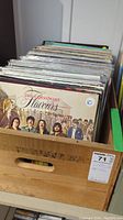 Wooden crate filled with vinyl LP records, showing overall lot and condition