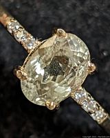 Close-up front view of the 10KT gold ring featuring the oval Zultanite center stone and diamond accented band.