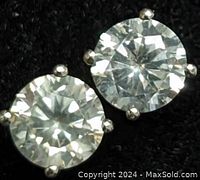 Front view of both diamond studs on black background