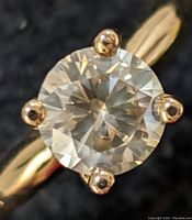 Top view showing round brilliant cut diamond and four-prong setting