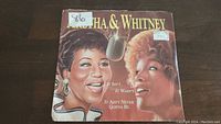 Front side of the 45rpm single sleeve showing illustrated portraits of Aretha Franklin and Whitney Houston with the title text.